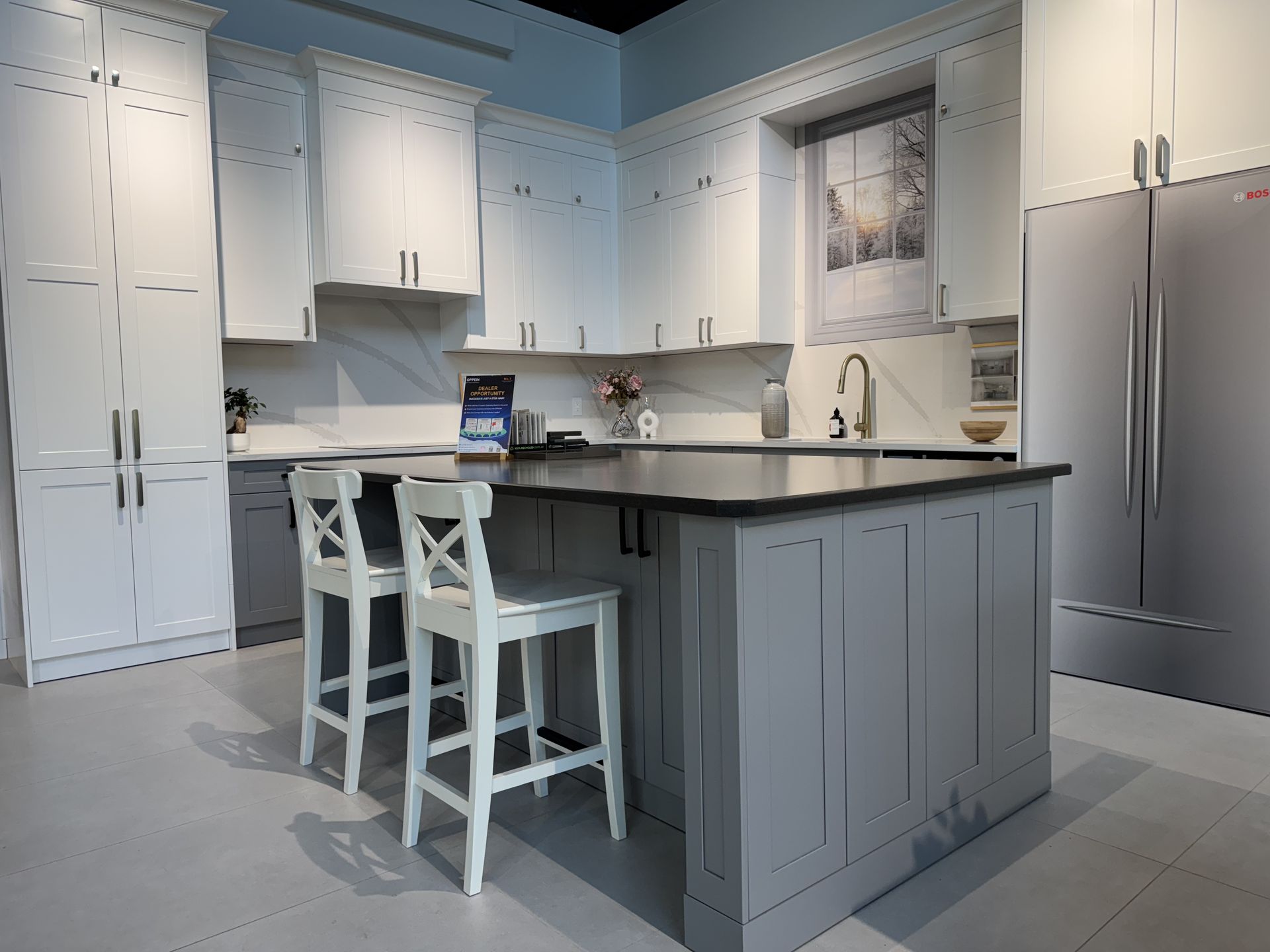 Shaker kitchen with white wall cabinets, a grey island and quartz countertops